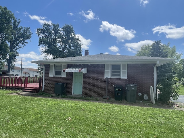 7725 S Oak Dr, Indianapolis, IN 46227 - view of front of property featuring a front yard, a wooden deck, brick siding, and a chimney