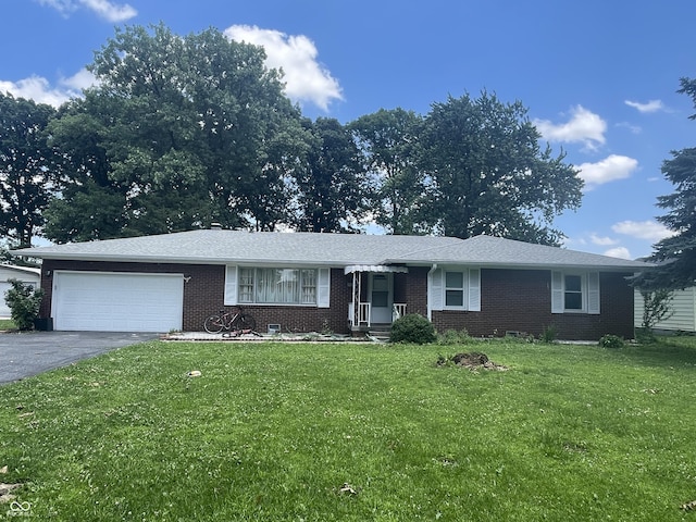 7725 S Oak Dr, Indianapolis, IN 46227 - ranch-style house with asphalt driveway, brick siding, a garage, and a front yard