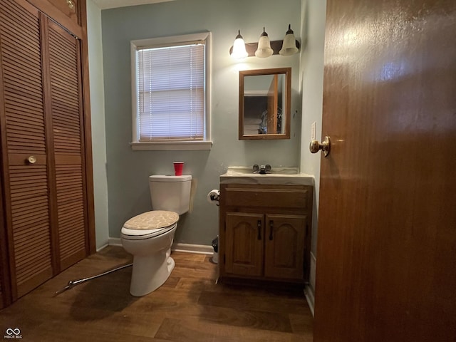 7725 S Oak Dr, Indianapolis, IN 46227 - bathroom featuring a closet, vanity, and wood finished floors