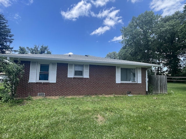 7725 S Oak Dr, Indianapolis, IN 46227 - view of home's exterior featuring brick siding, a yard, crawl space, and a shingled roof