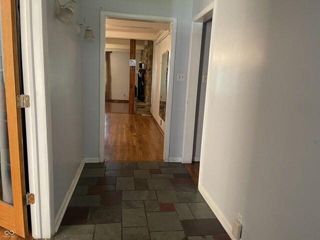 7725 S Oak Dr, Indianapolis, IN 46227 - hallway featuring dark stone finish floors and baseboards