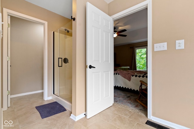 12214 Ridgeside Rd, Indianapolis, IN 46256 - ensuite bathroom with a stall shower, a ceiling fan, and tile patterned floors