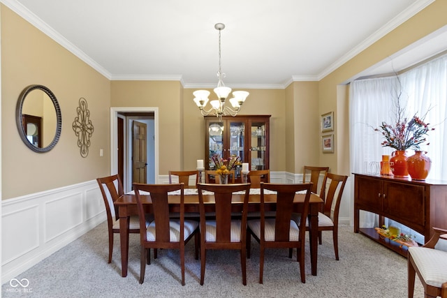 12214 Ridgeside Rd, Indianapolis, IN 46256 - dining area with a chandelier, light colored carpet, crown molding, and wainscoting