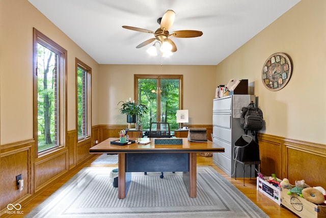 12214 Ridgeside Rd, Indianapolis, IN 46256 - office area featuring healthy amount of natural light, wainscoting, a ceiling fan, and light wood finished floors