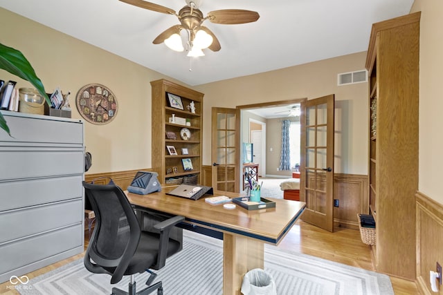 12214 Ridgeside Rd, Indianapolis, IN 46256 - office featuring french doors, a ceiling fan, wainscoting, and light wood-type flooring