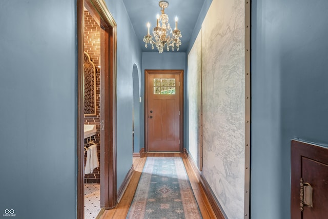 2421 W 39th St, Indianapolis, IN 46228 - doorway with a chandelier, arched walkways, and wood finished floors