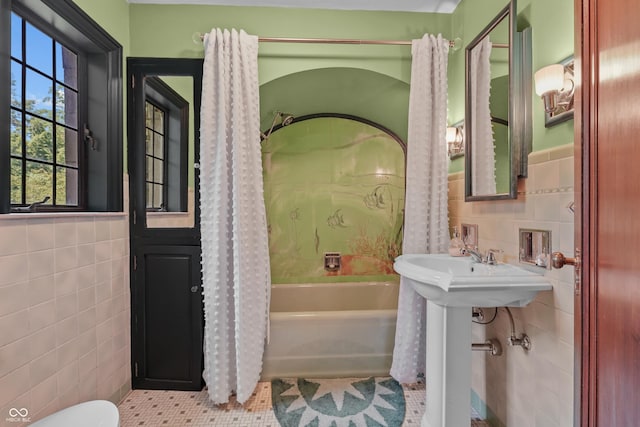 2421 W 39th St, Indianapolis, IN 46228 - full bathroom featuring tile walls, tile patterned flooring, shower / bathtub combination with curtain, and wainscoting