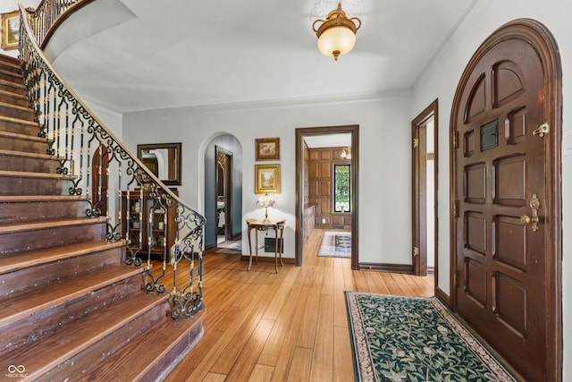 2421 W 39th St, Indianapolis, IN 46228 - foyer with arched walkways, stairway, and light wood finished floors