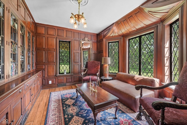2421 W 39th St, Indianapolis, IN 46228 - living area featuring a chandelier, light wood finished floors, and wooden walls