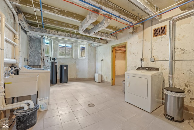 2421 W 39th St, Indianapolis, IN 46228 - below grade area with washer and clothes dryer, a water softener, and tile patterned floors
