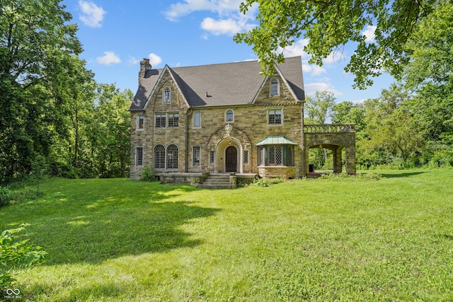2421 W 39th St, Indianapolis, IN 46228 - english style home featuring a chimney, stone siding, and a front lawn