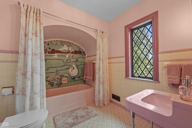 2421 W 39th St, Indianapolis, IN 46228 - bathroom with tile walls, a bath, wainscoting, and tile patterned floors