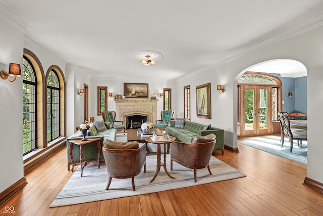 2421 W 39th St, Indianapolis, IN 46228 - living room with a fireplace, arched walkways, crown molding, wood-type flooring, and french doors