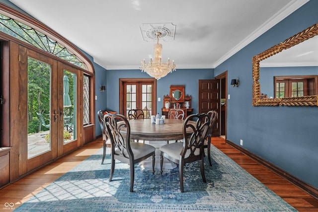 2421 W 39th St, Indianapolis, IN 46228 - dining room featuring french doors, a chandelier, healthy amount of natural light, wood finished floors, and ornamental molding