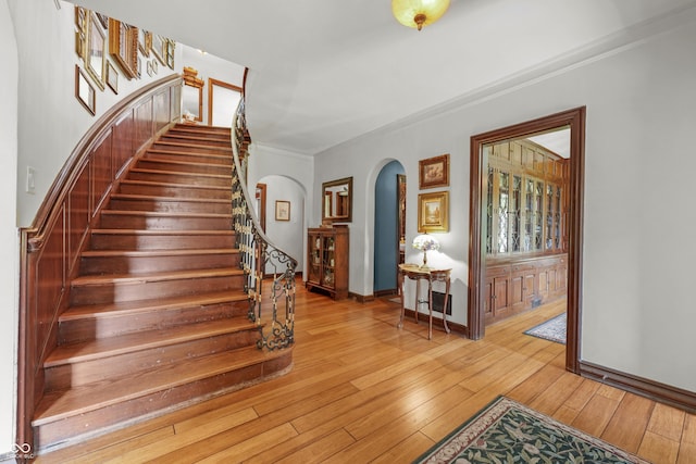2421 W 39th St, Indianapolis, IN 46228 - stairway with arched walkways, wood-type flooring, and crown molding