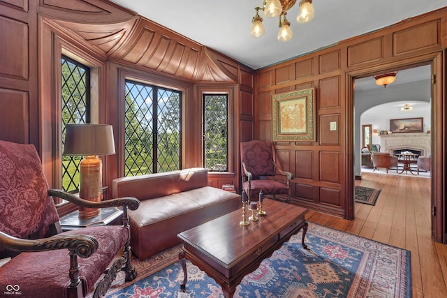 2421 W 39th St, Indianapolis, IN 46228 - living room with light wood-style flooring, arched walkways, a chandelier, and a fireplace