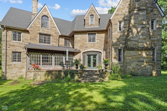 2421 W 39th St, Indianapolis, IN 46228 - view of front facade featuring french doors, a front lawn, a chimney, and stone siding
