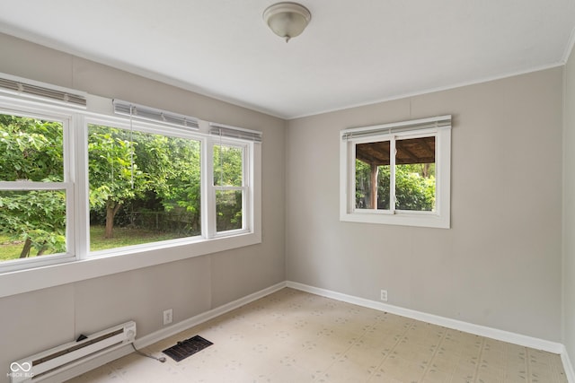 4517 E 16th St, Indianapolis, IN 46201 - spare room featuring baseboard heating, light flooring, and plenty of natural light