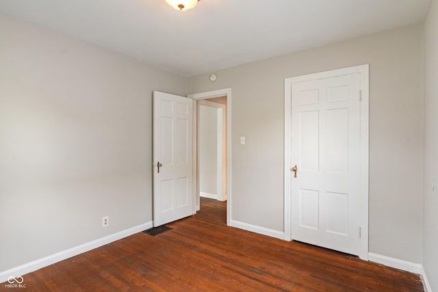 4517 E 16th St, Indianapolis, IN 46201 - unfurnished bedroom featuring dark wood-style flooring