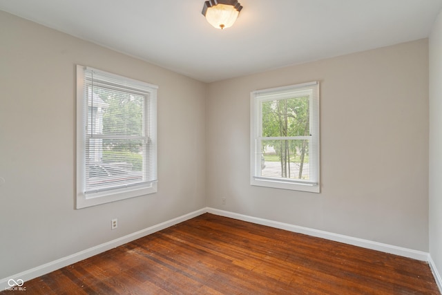 4517 E 16th St, Indianapolis, IN 46201 - unfurnished room with baseboards and dark wood-style flooring