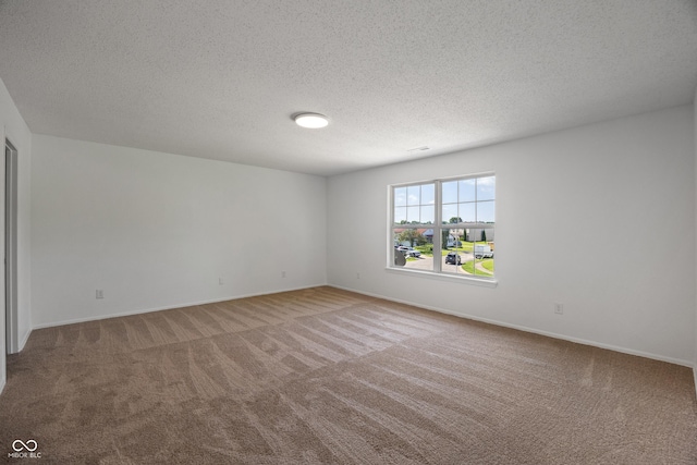 10222 Arapahoe Dr, Indianapolis, IN 46235 - carpeted spare room with baseboards and a textured ceiling