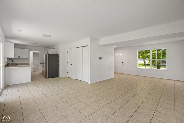 10222 Arapahoe Dr, Indianapolis, IN 46235 - unfurnished living room with a sink and light tile patterned floors