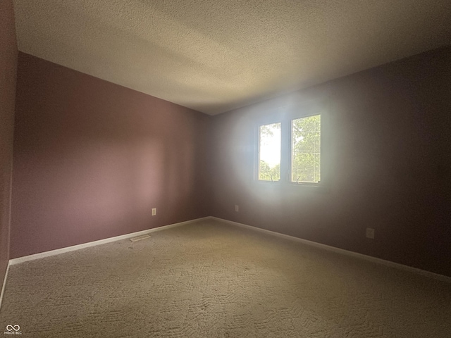 1289 Woodcreek Dr, Greenwood, IN 46142 - carpeted empty room with baseboards and a textured ceiling