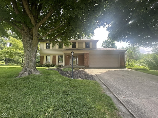 1289 Woodcreek Dr, Greenwood, IN 46142 - view of front facade with brick siding, an attached garage, a porch, driveway, and a front yard