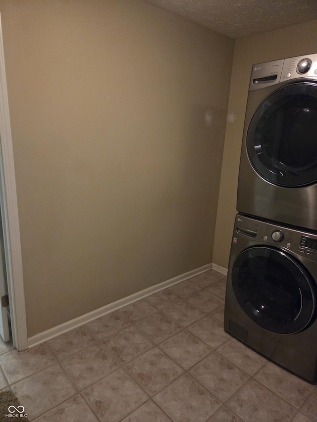 7440 Oakview Dr, Avon, IN 46123 - laundry area with stacked washer / drying machine, a textured ceiling, and light tile patterned floors