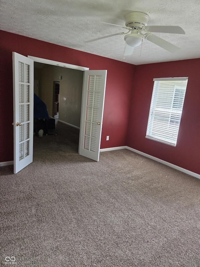 7440 Oakview Dr, Avon, IN 46123 - empty room with a ceiling fan, french doors, a textured ceiling, and carpet