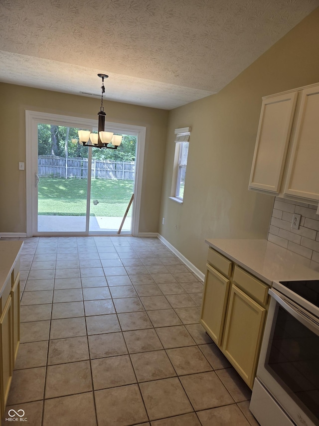 7440 Oakview Dr, Avon, IN 46123 - kitchen featuring electric range, plenty of natural light, a chandelier, light countertops, and a textured ceiling
