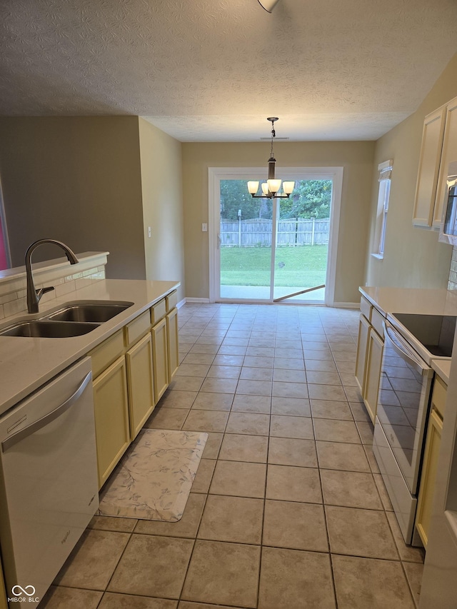 7440 Oakview Dr, Avon, IN 46123 - kitchen featuring white appliances, light countertops, a chandelier, light tile patterned flooring, and a textured ceiling