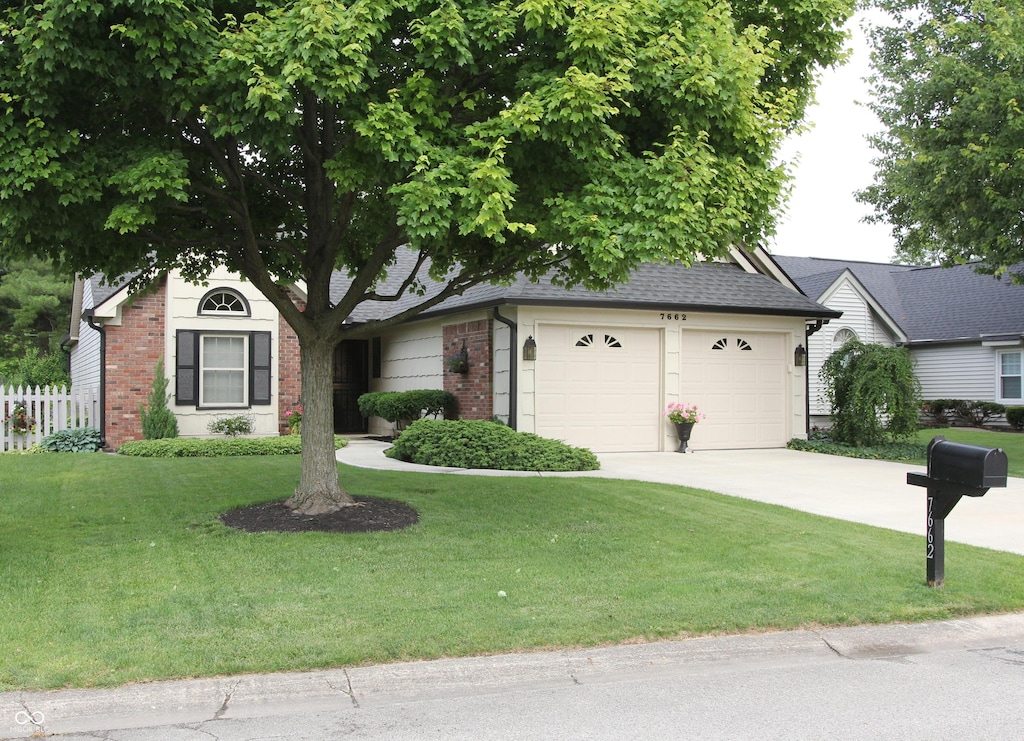7662 Micawber Ct, Indianapolis, IN 46256 - single story home featuring brick siding, driveway, a garage, and roof with shingles