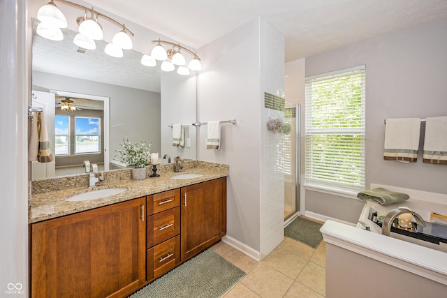 14052 Rayners Ln, Fishers, IN 46037 - bathroom with double vanity, tiled shower, tile patterned flooring, plenty of natural light, and a textured ceiling