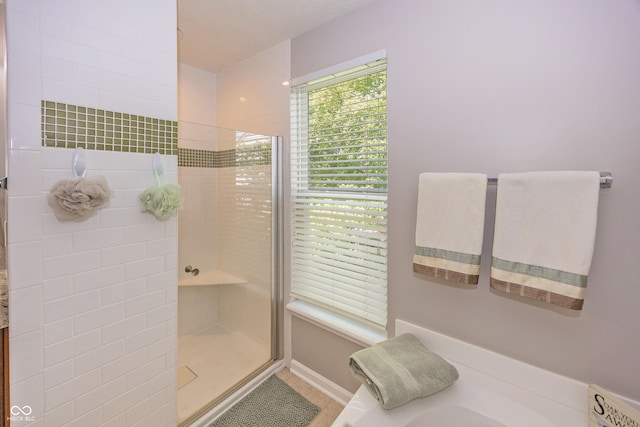 14052 Rayners Ln, Fishers, IN 46037 - bathroom with a stall shower, a bath, and tile patterned floors