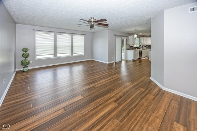 14052 Rayners Ln, Fishers, IN 46037 - unfurnished living room with a ceiling fan, dark wood-style floors, and a textured ceiling