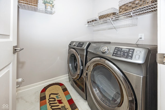 14052 Rayners Ln, Fishers, IN 46037 - laundry area with washing machine and clothes dryer and baseboards