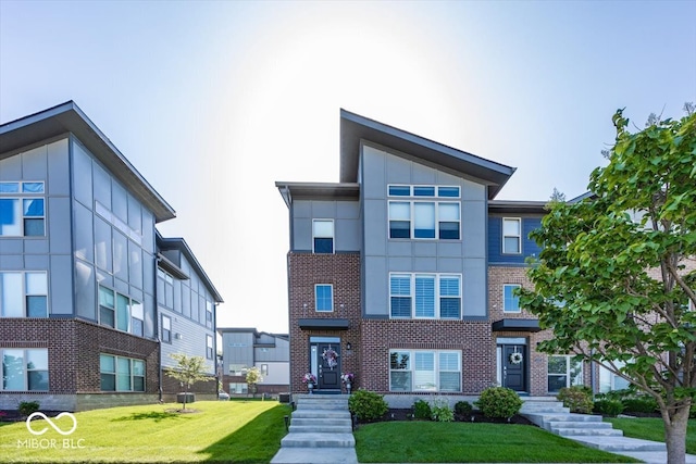 13301 Minden Dr, Fishers, IN 46037 - view of front of house featuring a front lawn, brick siding, and stucco siding