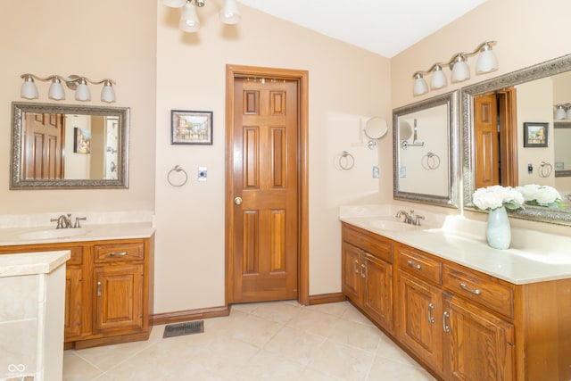 10518 Courageous Dr, Indianapolis, IN 46236 - full bath with two vanities, lofted ceiling, and tile patterned flooring