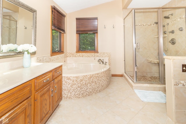 10518 Courageous Dr, Indianapolis, IN 46236 - bathroom featuring vanity, a bath, a shower stall, vaulted ceiling, and tile patterned flooring