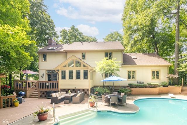 10518 Courageous Dr, Indianapolis, IN 46236 - rear view of house with a deck, a chimney, an outdoor living space, an outdoor pool, and a patio area