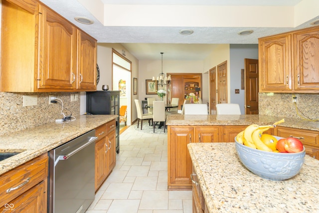 10518 Courageous Dr, Indianapolis, IN 46236 - kitchen featuring dishwasher, tasteful backsplash, light stone countertops, a chandelier, and brown cabinets