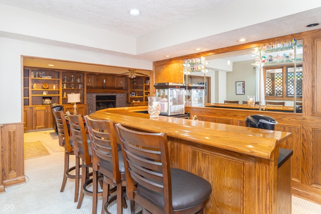 10518 Courageous Dr, Indianapolis, IN 46236 - indoor wet bar featuring recessed lighting, a textured ceiling, light colored carpet, a brick fireplace, and built in shelves