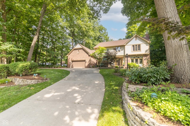 10518 Courageous Dr, Indianapolis, IN 46236 - traditional-style home featuring brick siding, a chimney, a detached garage, a front lawn, and driveway