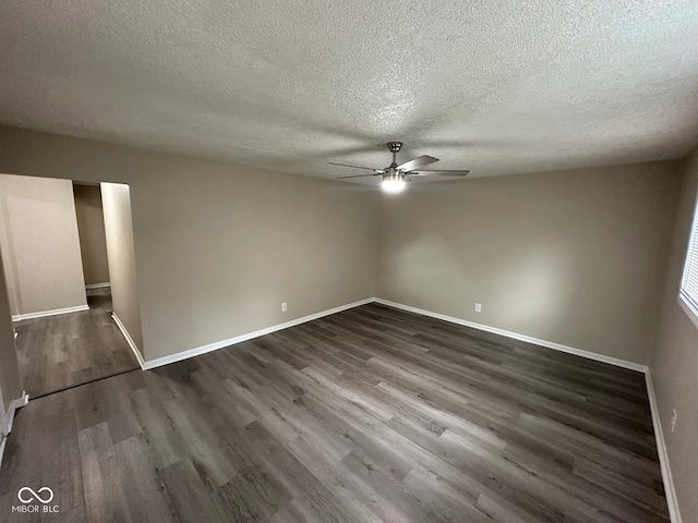 115 Hugo St, Indianapolis, IN 46229 - unfurnished room with a textured ceiling, a ceiling fan, and dark wood-style floors