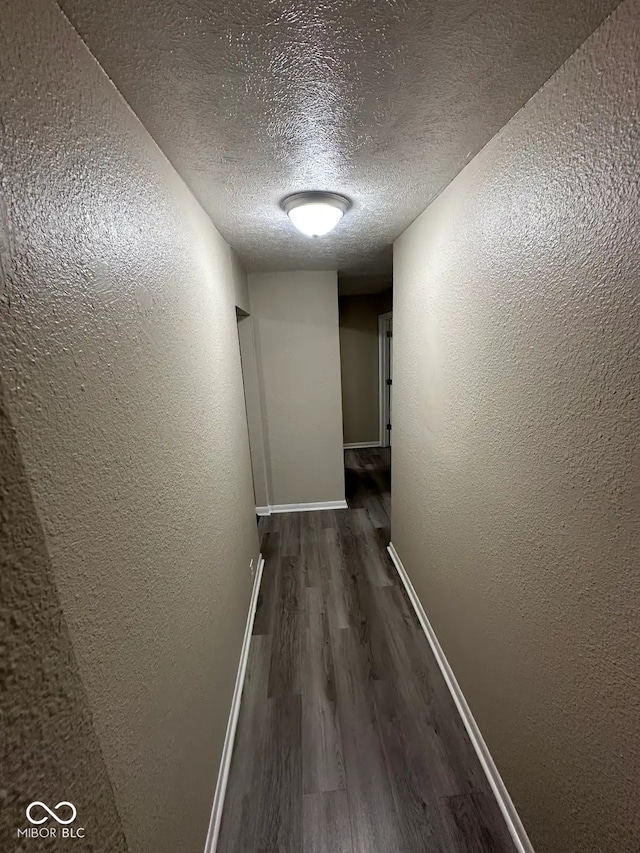 115 Hugo St, Indianapolis, IN 46229 - hallway with dark wood-type flooring, a textured ceiling, and a textured wall