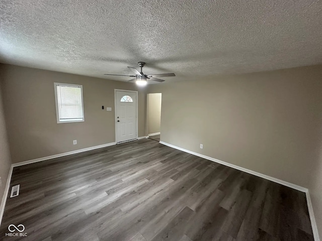 115 Hugo St, Indianapolis, IN 46229 - unfurnished living room featuring dark wood-type flooring, a textured ceiling, and ceiling fan