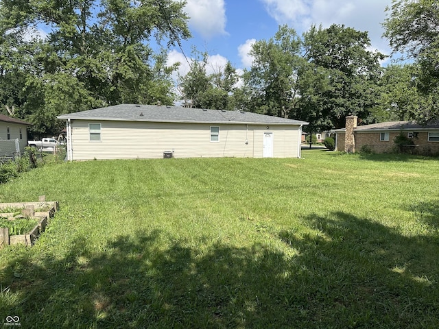 115 Hugo St, Indianapolis, IN 46229 - back of property featuring a lawn