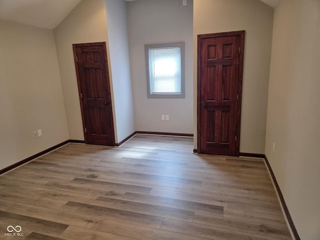 624 Warren Ave, Indianapolis, IN 46221 - spare room featuring vaulted ceiling and wood finished floors