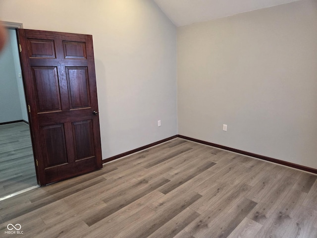 624 Warren Ave, Indianapolis, IN 46221 - unfurnished room with light wood finished floors and lofted ceiling